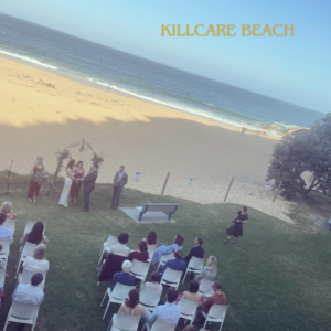 Photo of wedding ceremony with seated guests at Killcare Beach - catered by Pachamama Catering